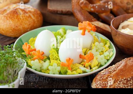 Easter breakfast with hard boiled eggs and bread rolls Stock Photo