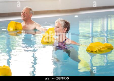Senior women and men in Rehabilitation training in a water gymnastics class Stock Photo