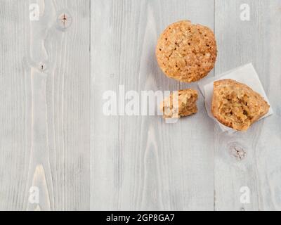 Top view of muffin with zucchini, carrots, apple and cinnamon on gray wooden background. Sweet vegetables homemade muffins. Toddler-friendly recipe id Stock Photo
