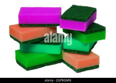 Closeup of a stack or heap of various colorful sponges or scouring pads isolated on a white background. Household chore concept. Top view. Macro. Stock Photo