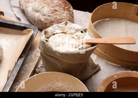 white wheat flour in a small burlap sack, close up Stock Photo