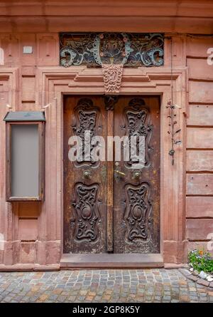 historic wooden ornamented door seen in Wertheim am Main in Southern Germany Stock Photo