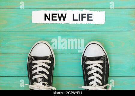 Sneakers standing next to words NEW LIFE Stock Photo