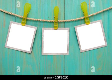 Empty picture frames hanging on rope Stock Photo
