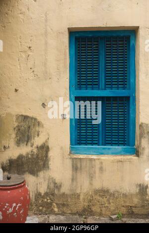 Blue shutters on a yellow wall, in Zanzibar africa. Stock Photo