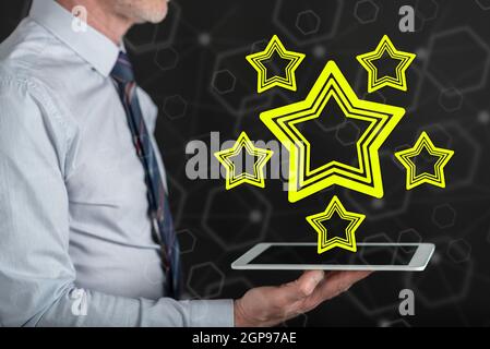 Quality concept above a tablet held by a man Stock Photo