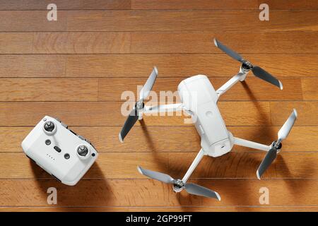 small drone copter with controller on a wooden background Stock Photo