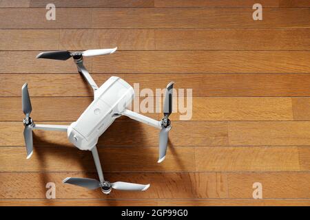 small drone copter on a wooden background Stock Photo