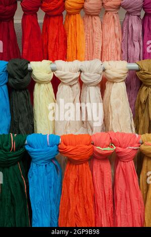 Colorful shawls or scarfes in a market stall Stock Photo