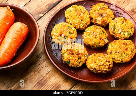 Plate with dietary vegetarian lentil and carrot cutlets.Diet food.Vegetable cutlets on wooden rustic table. Stock Photo
