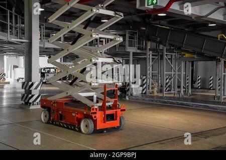 distribution warehouse hall with hydraulic scissors lift platform Stock Photo