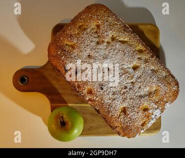 Apple Plum Cake decorated with an apple on a cutting table Stock Photo