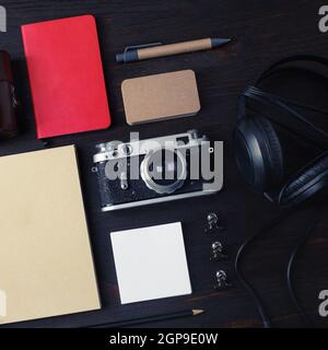 Retro camera with travel accessories and items on wooden background. Top view. Flat lay. Stock Photo