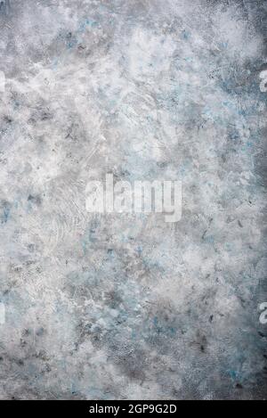 Gray textured concrete wall background with blue spots Stock Photo