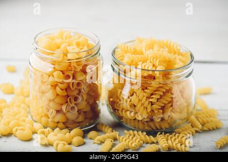 Two kinds of Italian whole wheat pasta in glass jars Stock Photo