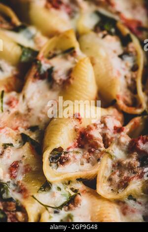 Baked jumbo shells pasta stuffed with ground beef, spinach and cheese Stock Photo