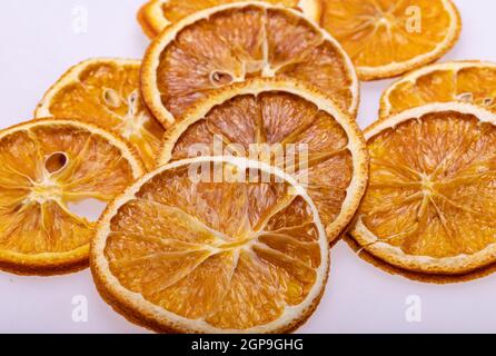 Dried orange slices. Dehydrated crispy fruits for decorating dishes for drinks, desserts and cocktails. Stock Photo