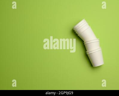 stack of white paper cups on a pink background. Plastic rejection concept, zero waste, copy space Stock Photo