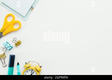Paper clips, mechanical clock, pencil, scissors on white background. Work and education concept. High quality photo Stock Photo