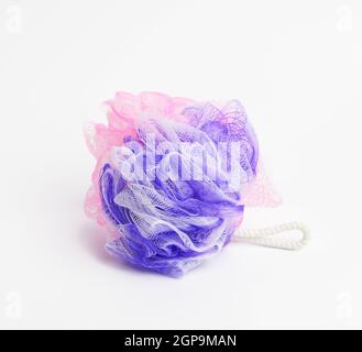 multicolored plastic washcloth on a white background, close up Stock Photo
