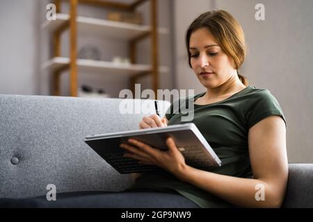 Designer Hand Drawing On Convertible Laptop Computer Stock Photo