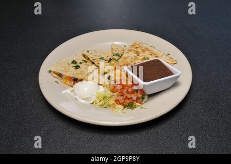 The mexican delicacy known as a black bean quesadilla Stock Photo