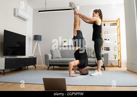 Man Doing Yoga Headstand Exercise Training At Home Stock Photo