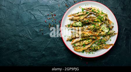 Fried capelin fish with herbs and lemon zest.Fish dish Stock Photo