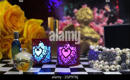 Yellow Roses With Perfume and Jewelry on VAnity Table Stock Photo