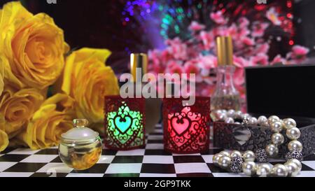 Yellow Roses With Perfume and Jewelry on VAnity Table Stock Photo