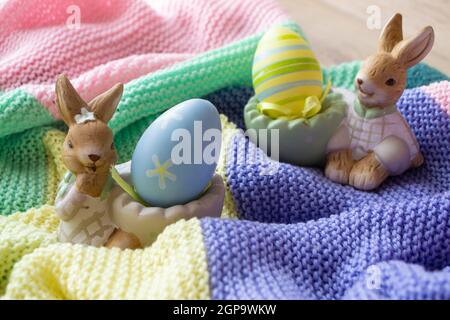 beautiful Easter eggs and bunny on colorful knitted background Stock Photo