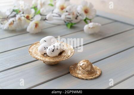 Straw hat decorated for easter with flowers and easter eggs for spring decoration Stock Photo