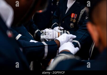 Members of the United States Air Force Honor Guard put their hands in during a team huddle before performing in Times Square, New York City, New York, Sept. 17, 2021. The Honor Guard and The United States Air Force Band performed in Times Square and then live the next day at the Intrepid Sea, Air & Space Museum for the Fox and Friends morning show in commemoration of the Air Force’s 74th Birthday. (U.S. Air Force Photo by Staff Sgt. Kevin Tanenbaum) Stock Photo