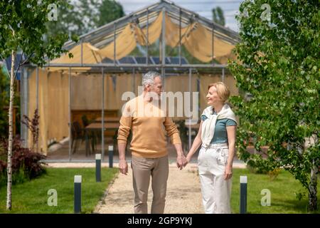 Loving husband and his joyful wife standing outdoors Stock Photo