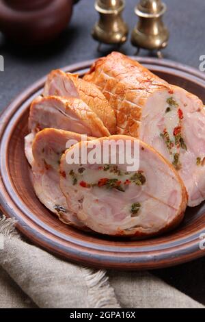 Chicken roll. Sausage made from poultry meat. Dietary meat. Spice appliances made of brass. Vertical photo. Top view. Stock Photo