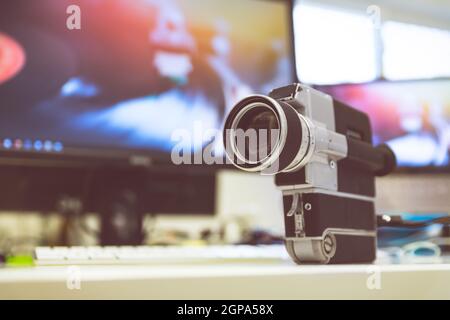 Vintage old movie camera, computer for cutting in the blurry background Stock Photo