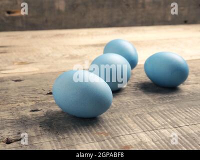 Naturally colored organic eggs on a rustic table with space for text, Easter background Stock Photo
