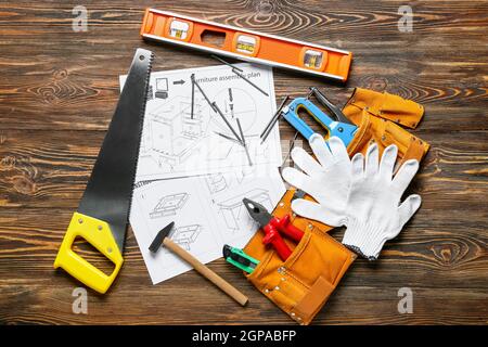 Furniture assembling plan and set of tools on wooden background Stock Photo