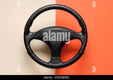 Modern steering wheel on color background Stock Photo