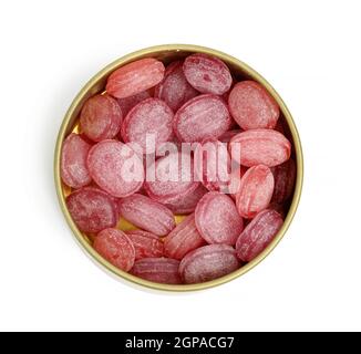 fruit oval lollipops in an open round tin can on a white background, top view Stock Photo