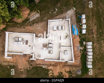 Aerial image of a new family house being built. New private housing development construction in rural countryside aerial view. Stock Photo