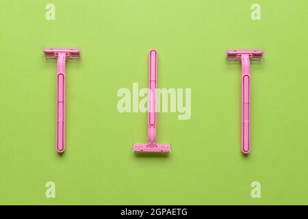 Safety razors on green background Stock Photo