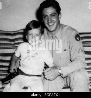 portrait of father and son in military uniforms with toy plane isolated