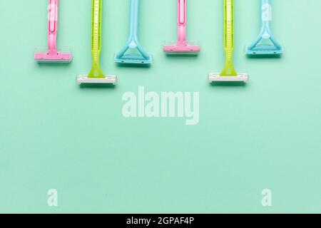 Many different razors for depilation on blue background, closeup Stock Photo