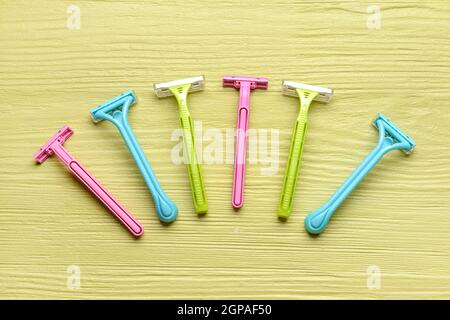 Many different razors for depilation on color wooden background Stock Photo