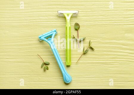 Safety razors on color wooden background Stock Photo - Alamy