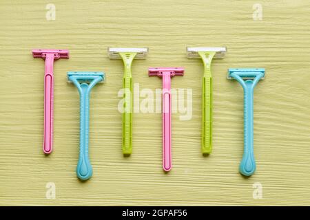 Many different razors for depilation on color wooden background Stock Photo