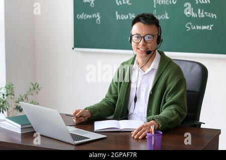 Asian teacher conducting English lesson online Stock Photo