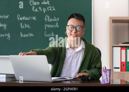 Asian teacher conducting English lesson online Stock Photo