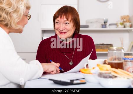 Cheerful elderly women with documents Stock Photo